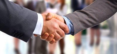 a close up of two people shaking hands.