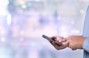 a close up of a person holding a cell phone.