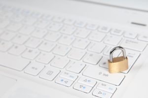 a padlock sitting on top of a computer keyboard.